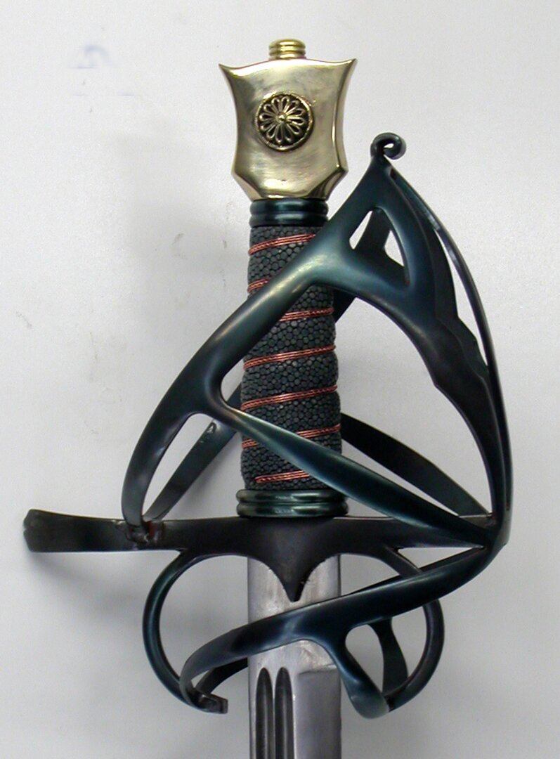 Fairly simple early Schiavona guard with a bled hilt, rayskin and wire grip and bronze Cats head Pommel.